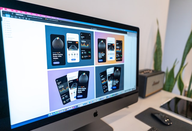 iMac displaying mobile app mockups in a design tool
